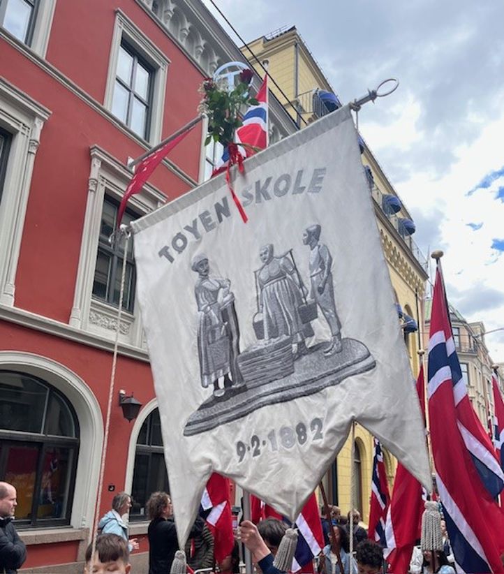 et stort banner med en gruppe mennesker foran en bygning et stort banner med en gruppe mennesker foran en bygning